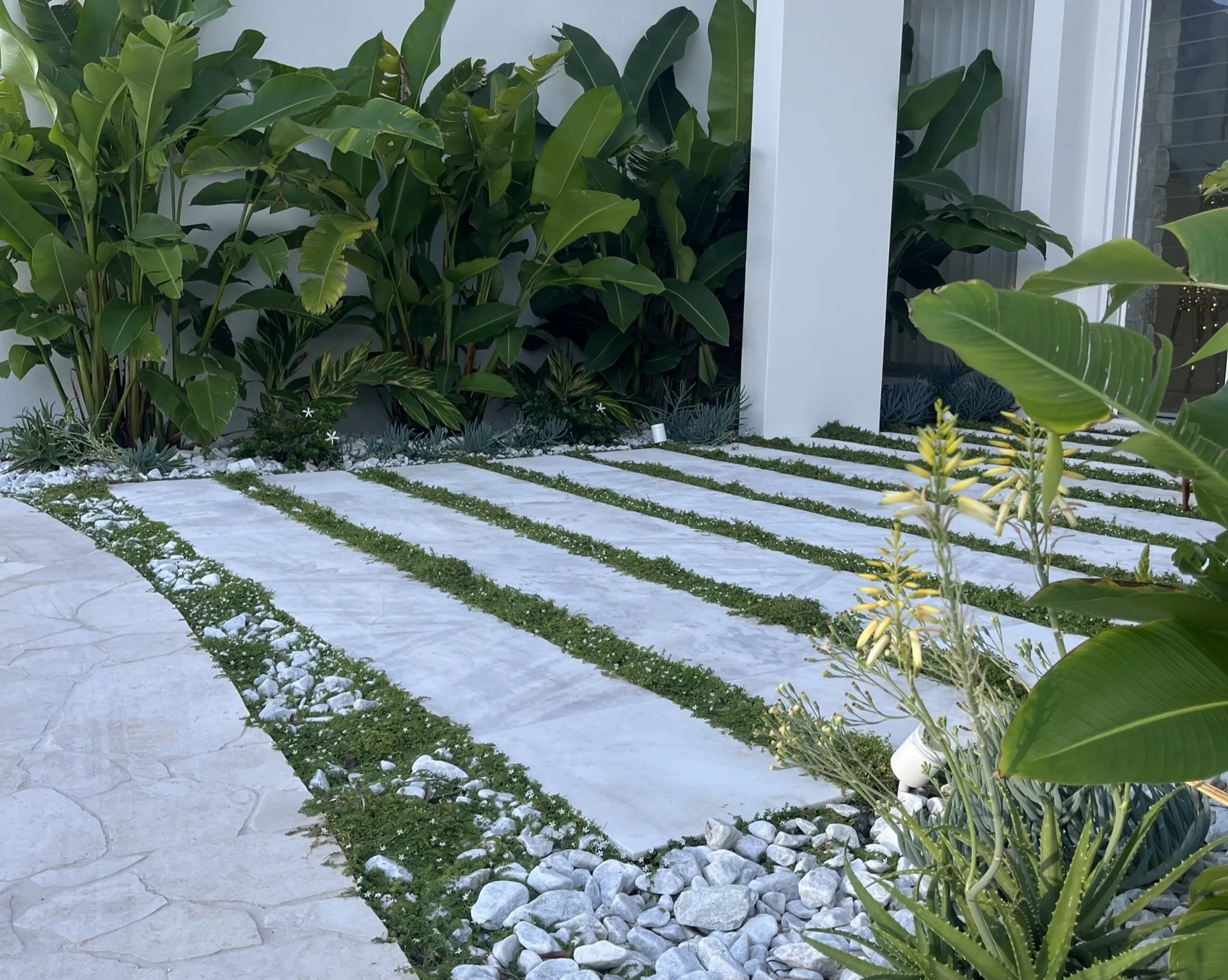 Finished landscaped backyard with lawn and paving